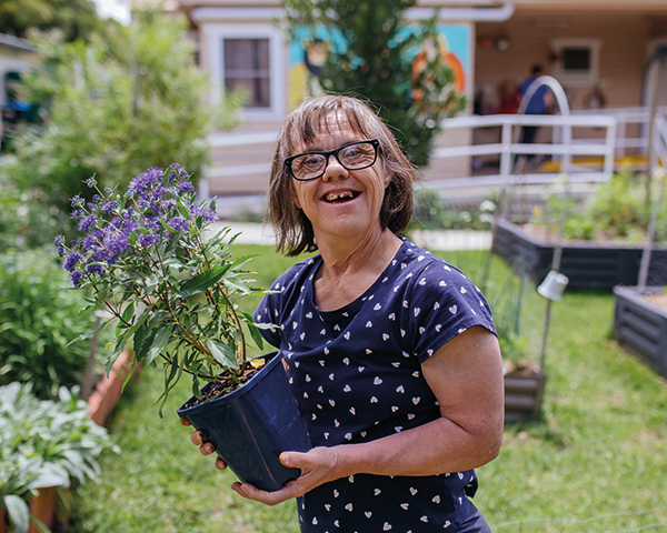 Garden house lady holding plant